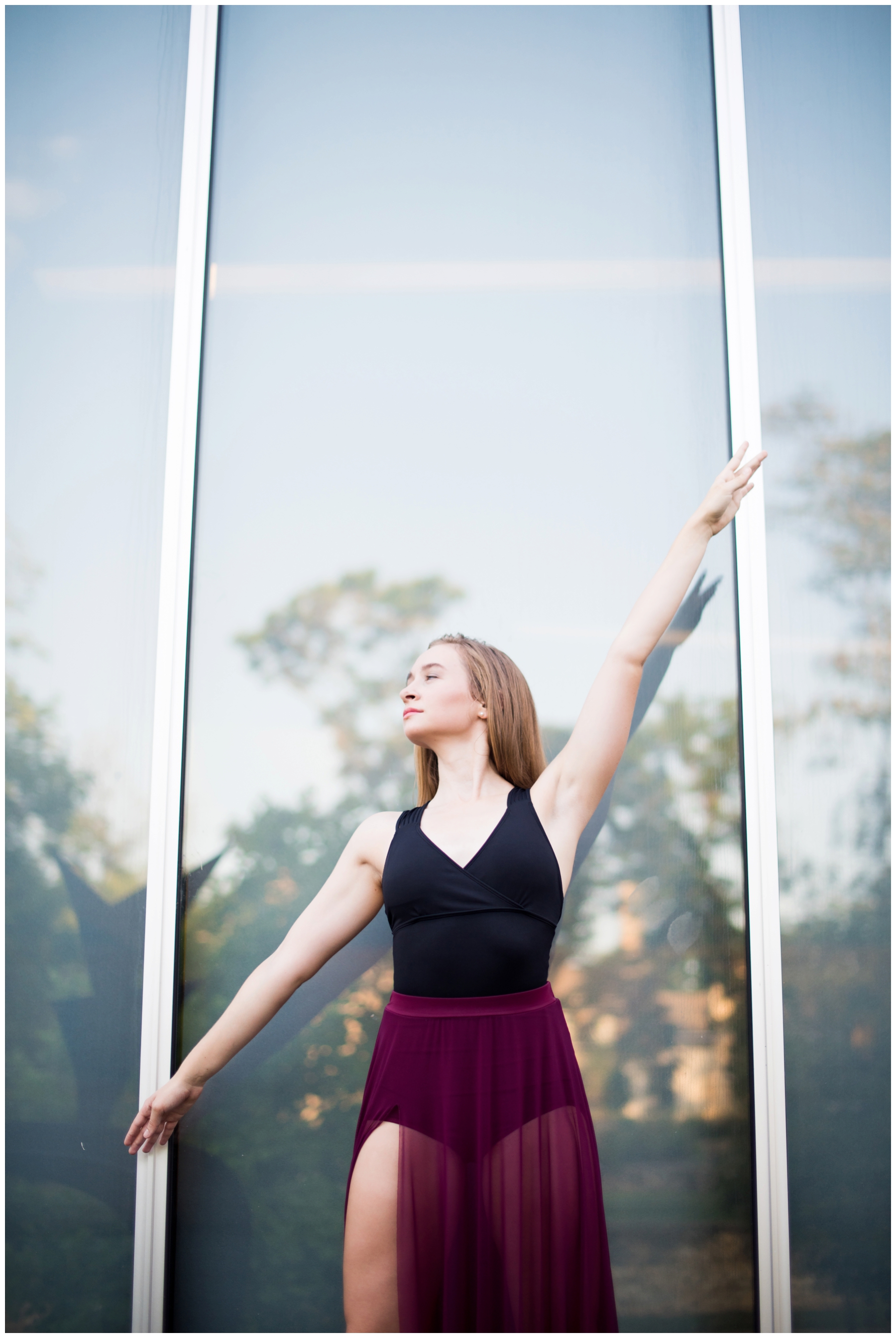 An elegant high school senior photo shoot in downtown kansas city at nelson atkins museum with modern dance and sunset lighting