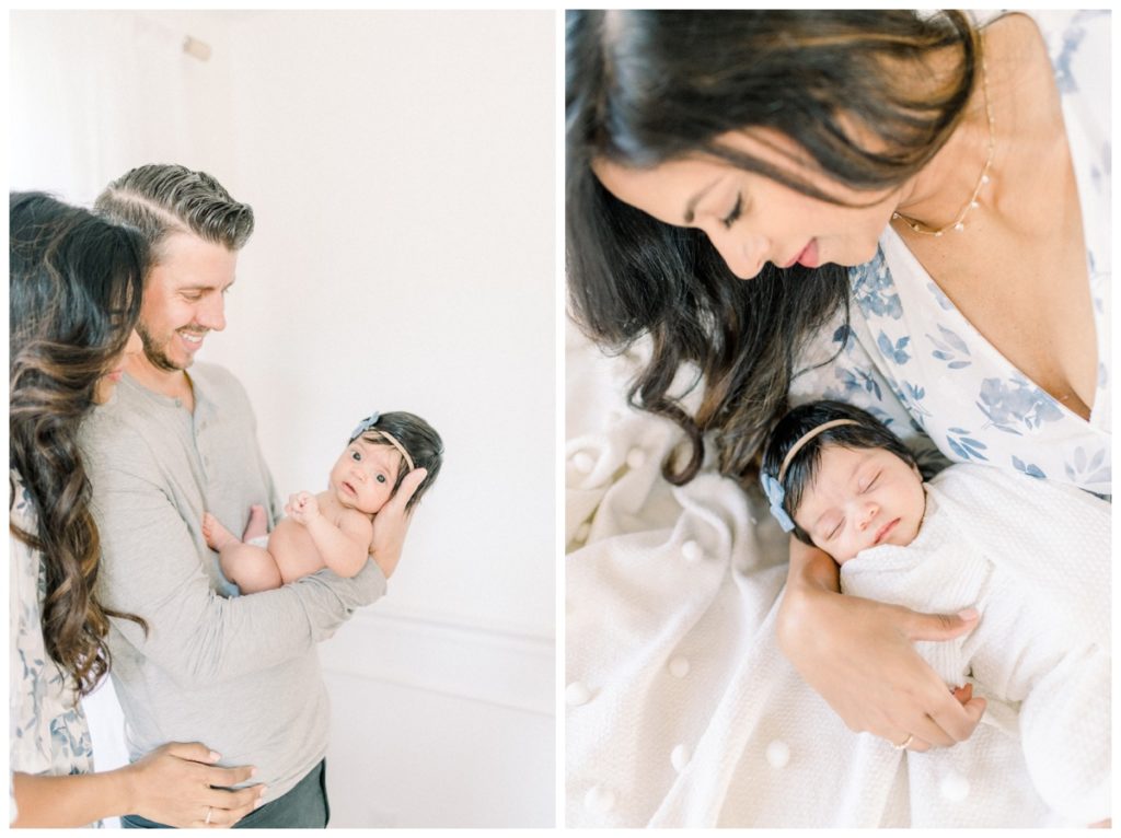 Photos of young parents holding their newborn daughter in a natural light, white studio while smiling down at her.