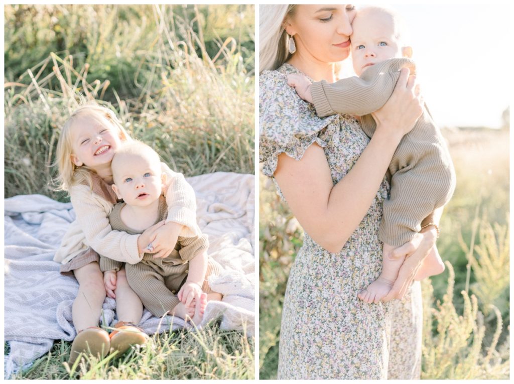 Photo of a young blonde mother in a ditsy floral dress holding her six month old son in a wheat field while the light filters in. 