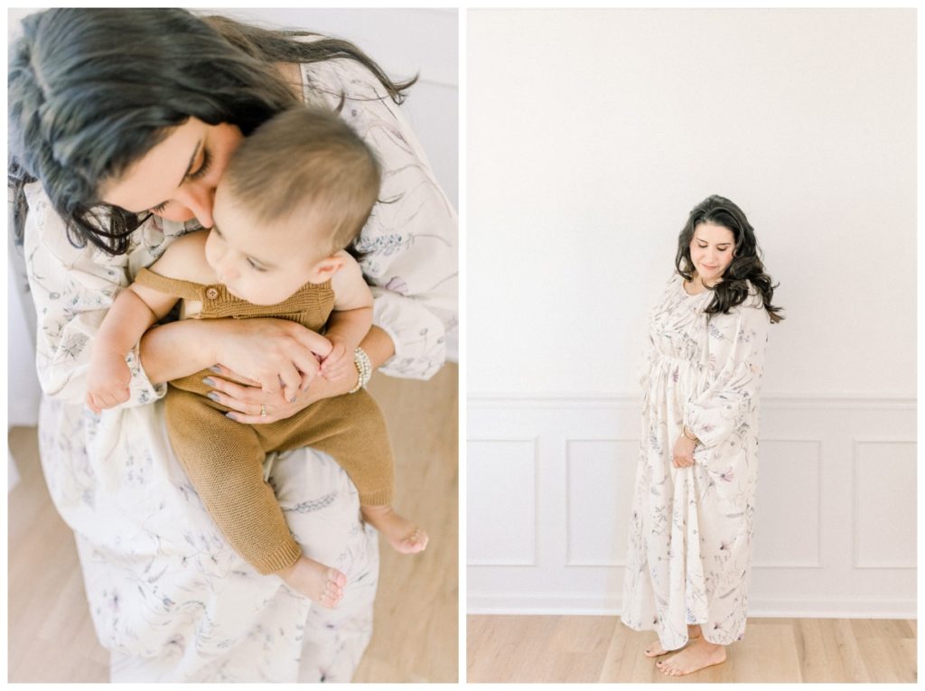 Picture of a young mom wearing a cream floor length cotton dress with soft watercolor flowers on it in a white studio with natural wood floors. 