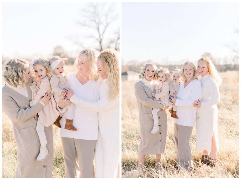 Picture of three generations of women while the grandma has on a white sweater and is holding her youngest granddaughter in a cream dress and bow while her daughters are on either side of her with the other granddaughter. 