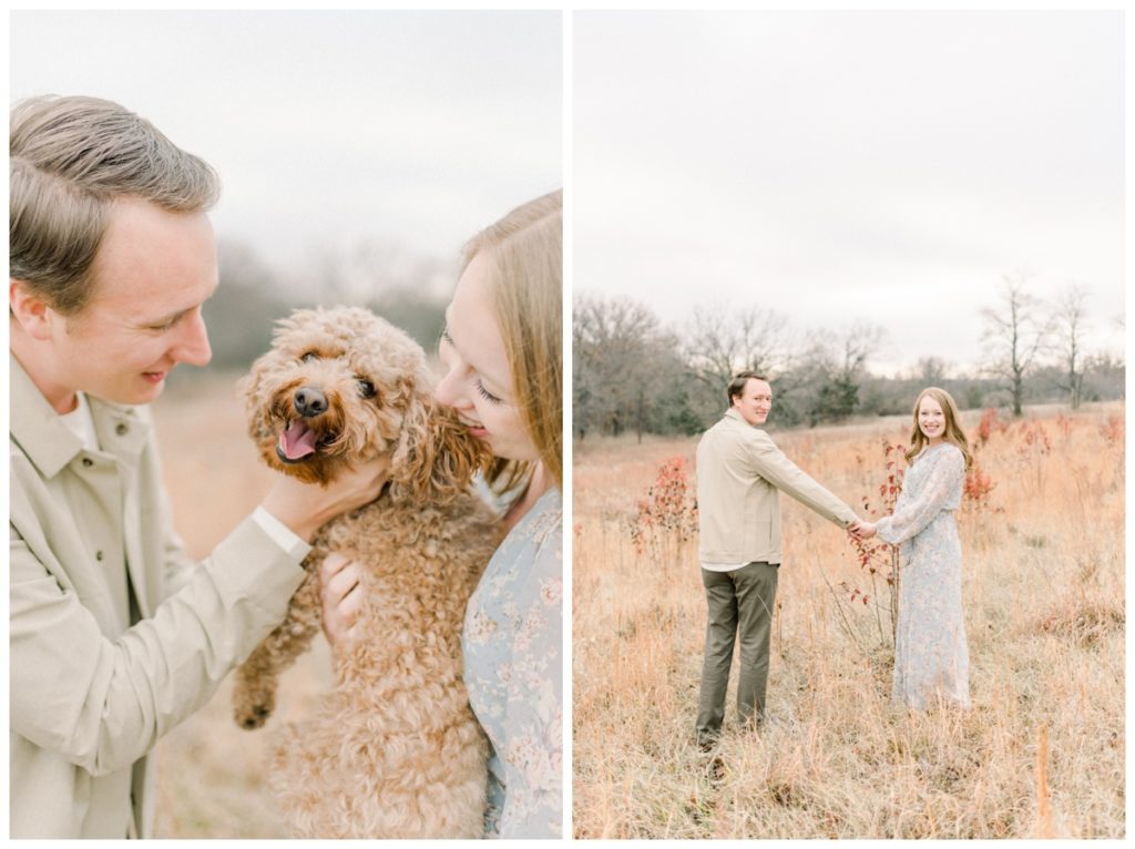 Photo of a husband and wife smiling holding their golden doodle puppy in between them looking at her while the puppy looks at the camera. 